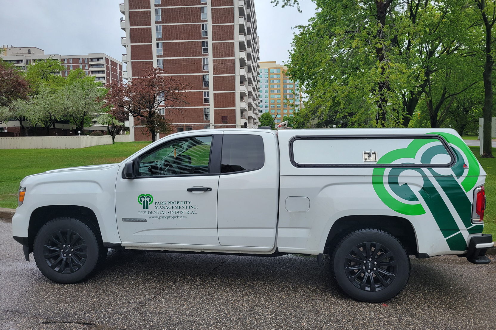 Park Property Management truck outside an apartment building.