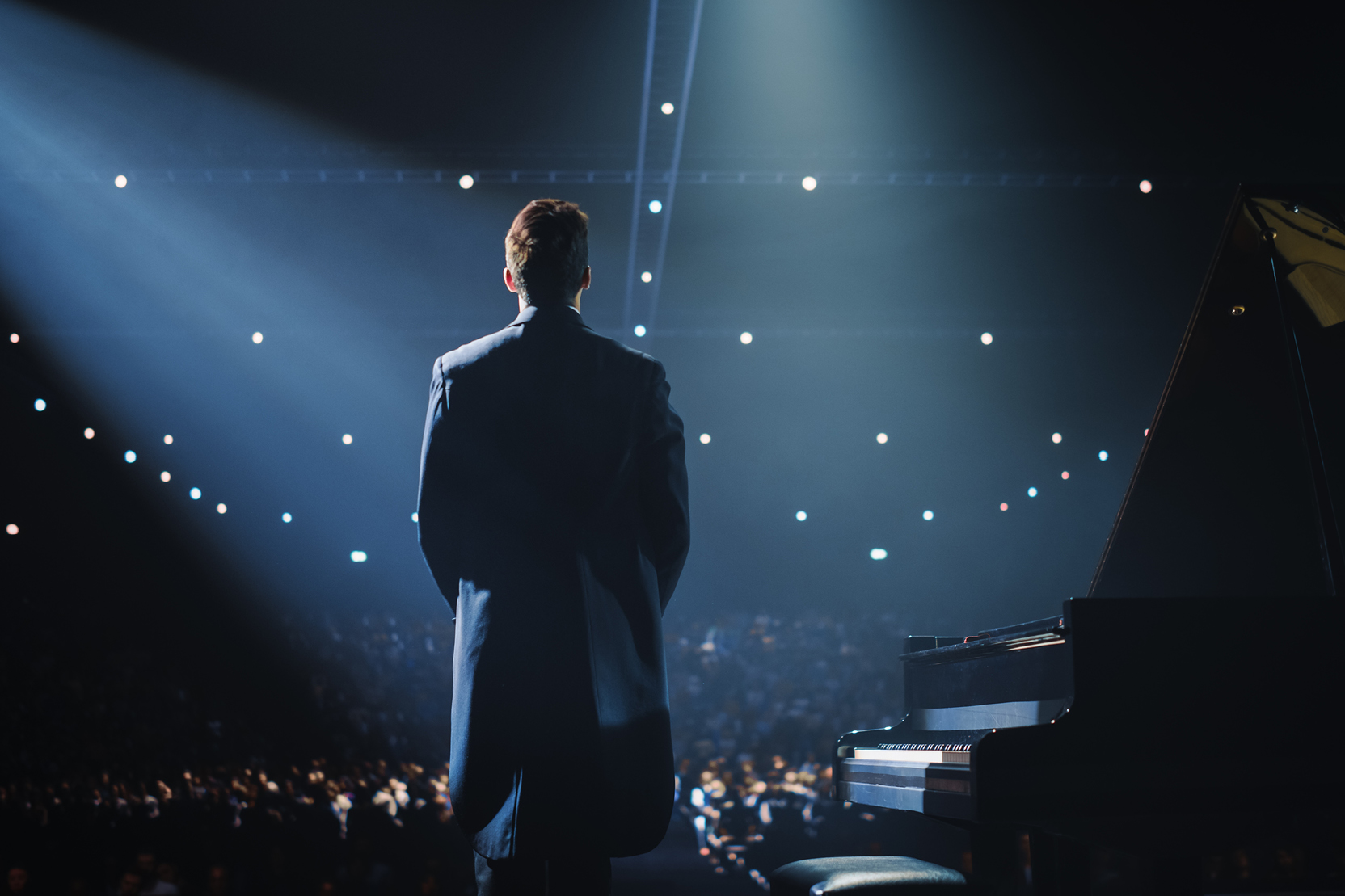 A performer looks out into the audience from the stage.