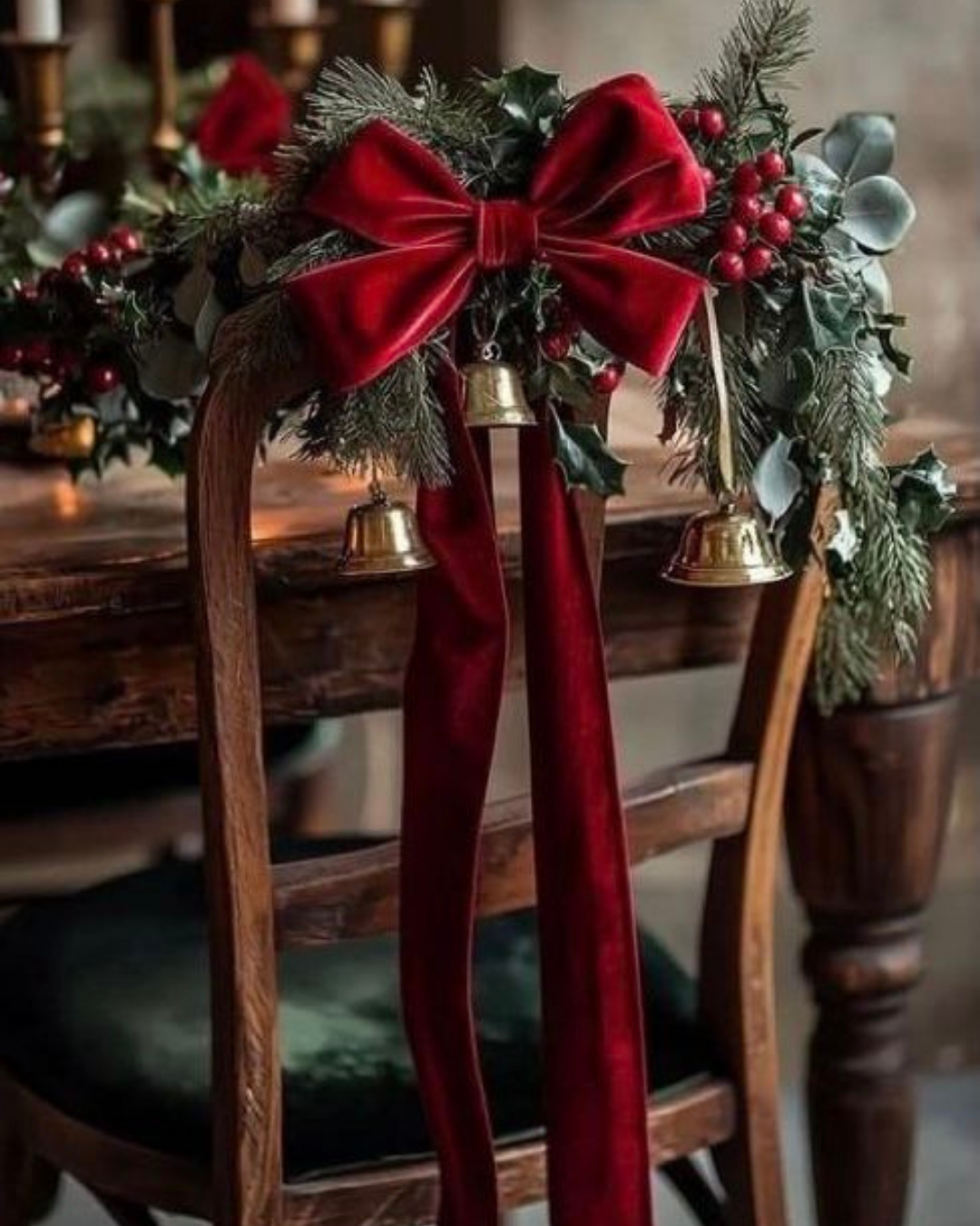 Wooden chair decorated with a festive red velvet bow, greenery, and golden bells — classic holiday details in a vintage-inspired luxury apartment.