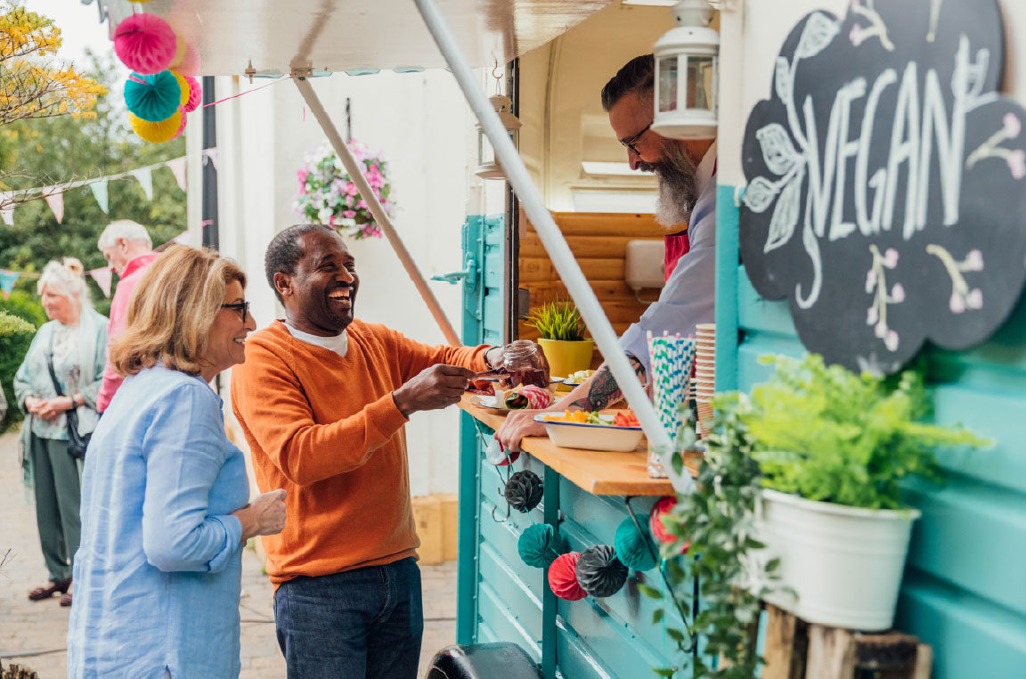 A couple ordering food from a locally owned food truck at a festival